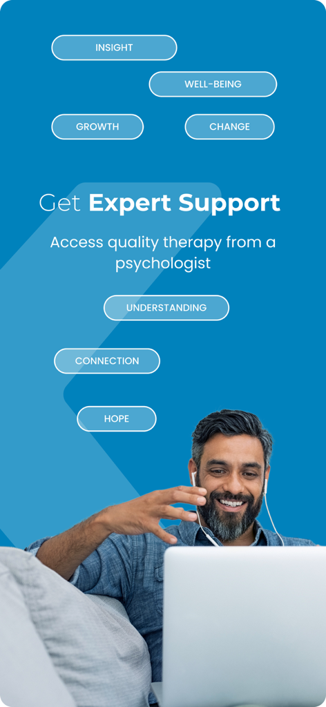 A man smiling while participating in an online therapy session on his laptop