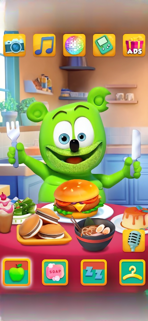 My Talking Gummy Bear - El personaje Osito Gominola verde sentado a una mesa llena de comida, incluyendo una hamburguesa y ramen