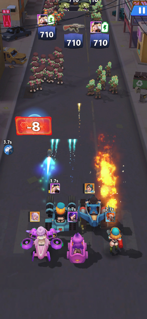 배틀 키스의 탑다운 슈팅 게임 플레이로, 여성 캐릭터와 차량이 도시 거리에서 좀비 떼와 싸우고 있습니다.