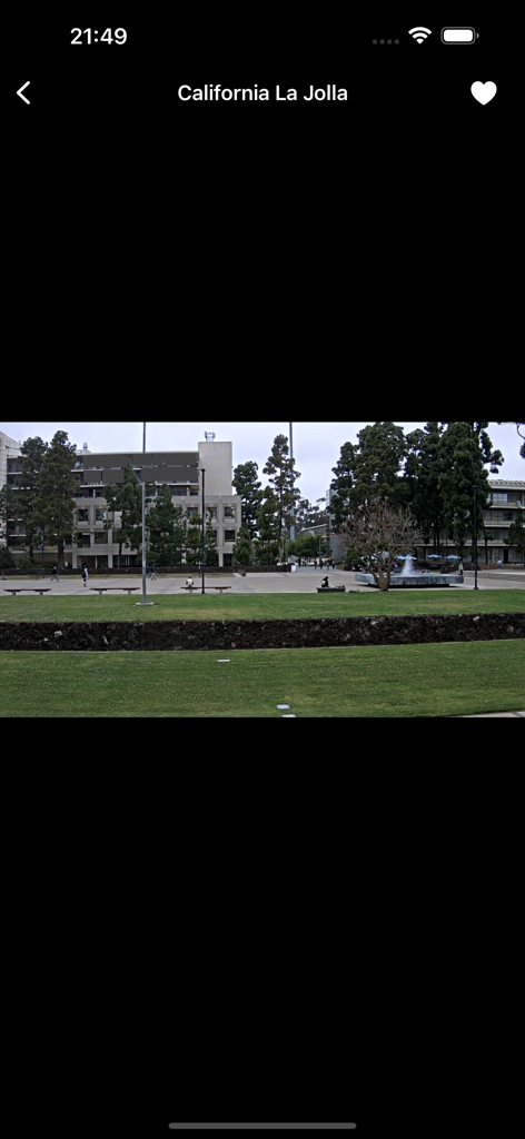 Live camera view of a public square and buildings in La Jolla California within the USA Cameras app interface