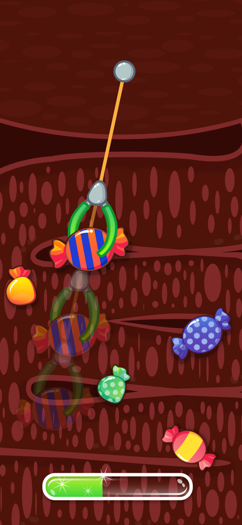 Doctor Pets - Animal Vet Games - Un mini-jeu de l'application Doctor Pets où une pince mécanique attrape des bonbons colorés pour soigner les maux d'estomac d'un animal de compagnie.