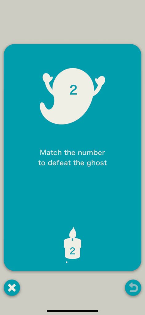 A gameplay screen from the KaruQ app showing a ghost and a flame both marked with the number two with instructions to match numbers to defeat the ghost