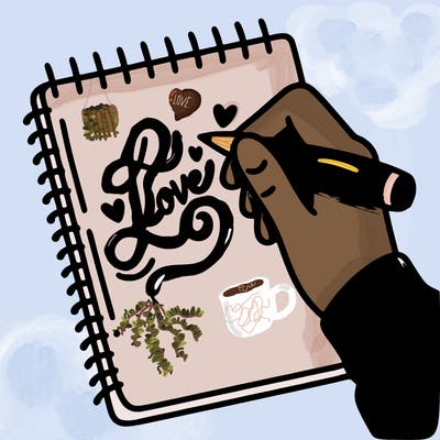 a hand writing “love” in calligraphy on a notebook