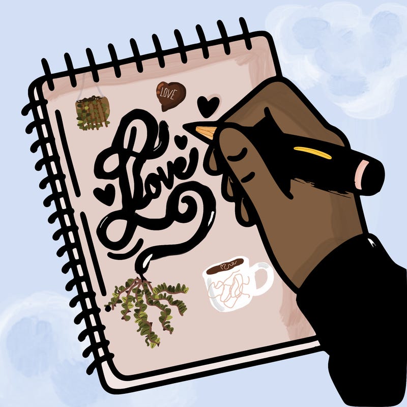 a hand writing “love” in calligraphy on a notebook
