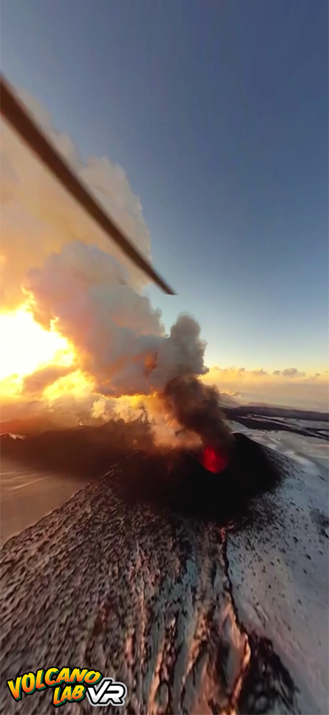 Steam Lab VR - Aerial virtual reality view of an erupting volcano with glowing red lava and thick smoke plumes