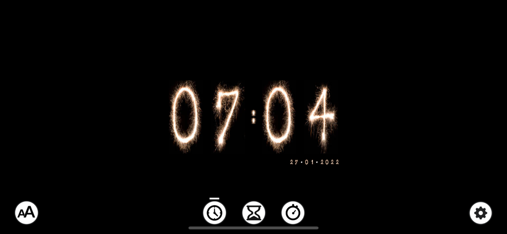 A digital clock showing the time in a glowing sparkler font on a black background