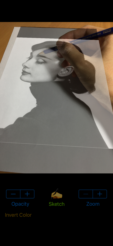 Vermeer's Lens: AR Drawing - A person using the Vermeers Lens AR app to trace a portrait photo onto physical paper with a pencil