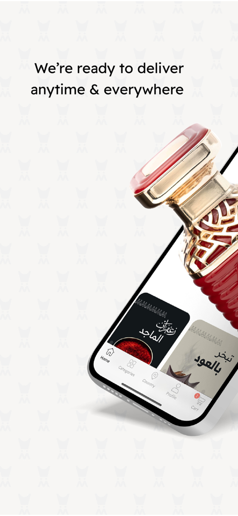 Almajed4oud - الماجد للعود - Une bouteille de parfum rouge et dorée de luxe à côté d'un smartphone montrant l'application d'achat mobile Almajed4oud avec du texte de livraison.