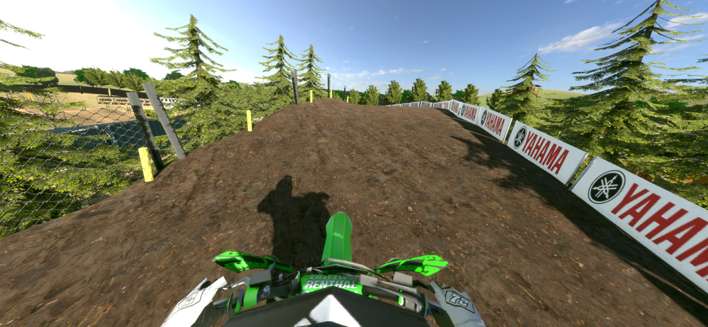 First-person view of a dirt bike riding on a 3D motocross track.