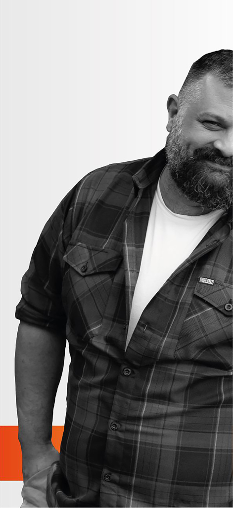 W | Bear - A smiling bearded man in a plaid shirt representing the W Bear community