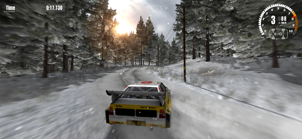 Rush Rally 3 - A white rally car racing on a snow covered track through a forest in the Rush Rally 3 simulation game