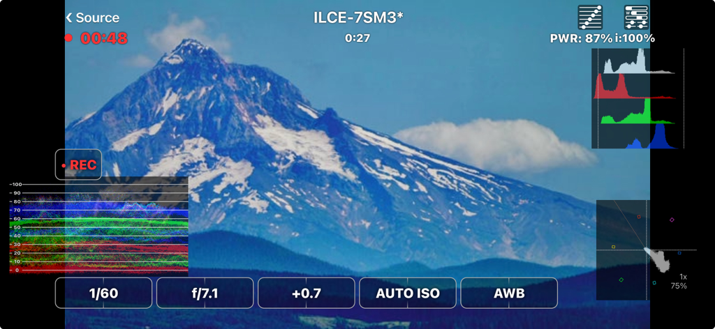 FieldMonitor - FieldMonitor app interface showing waveform histogram and camera controls on a mountain landscape shot