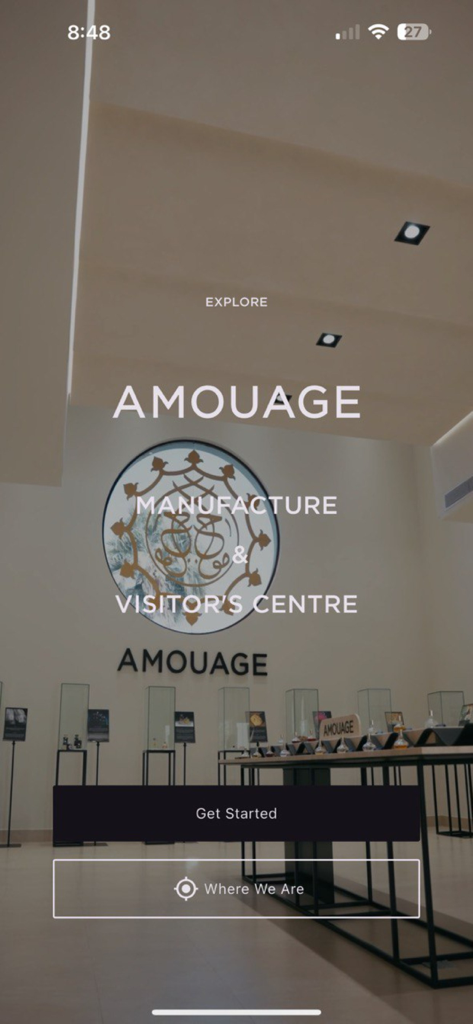 Amouage Visitors' Center - The home screen of the Amouage Visitors Center app featuring buttons to explore the manufacture and view its location