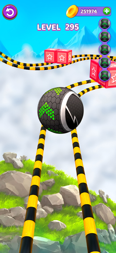 Una bola negra y verde rodando sobre rieles a rayas sobre un paisaje montañoso