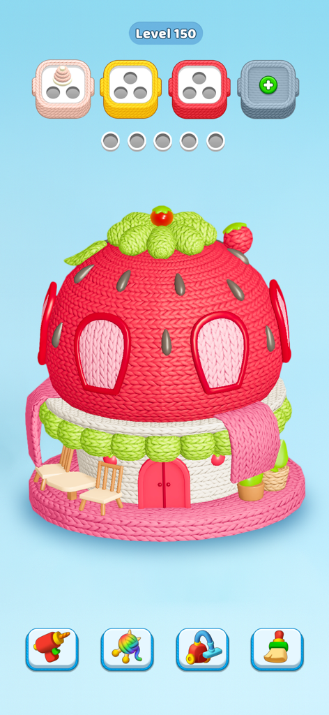 A 3D knitted strawberry house puzzle in the Knit Away mobile game.