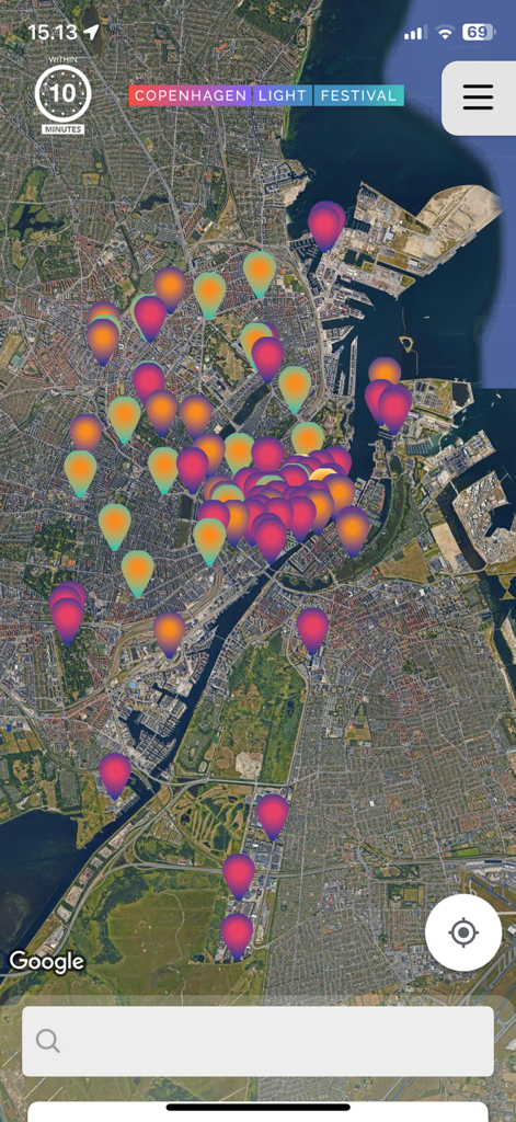 A satellite map view of Copenhagen in the official light festival app showing numerous event locations with colorful pins
