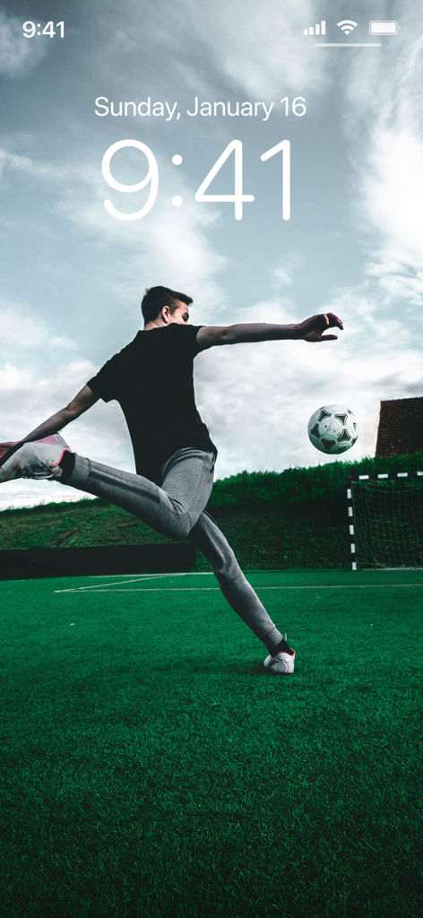 Football Wallpapers 4K | HD - Action shot of a football player kicking a ball in mid-air on a green pitch