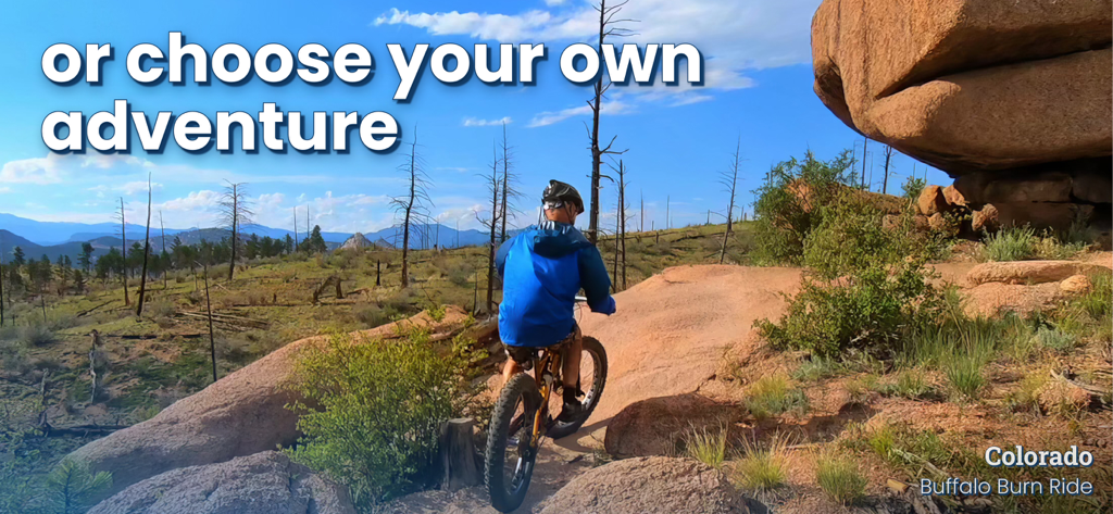 A person mountain biking through a scenic rocky landscape in Colorado as part of a virtual workout in the BitGym app.