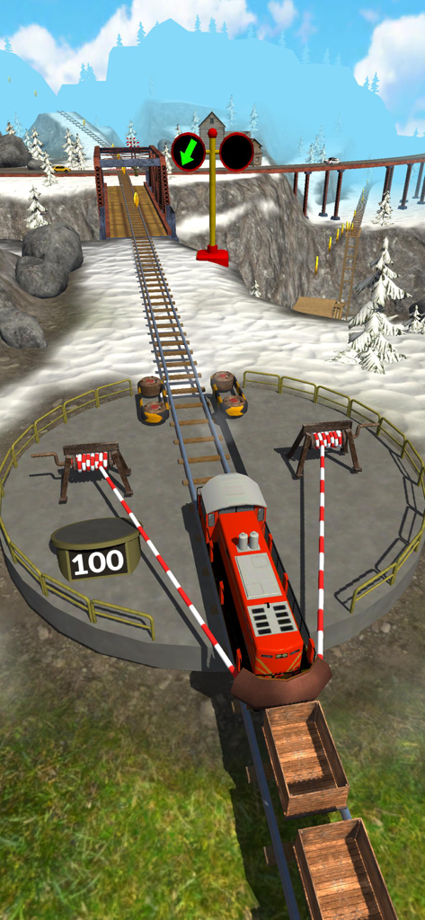 A red train engine positioned in a large slingshot on a railway track in a snowy environment