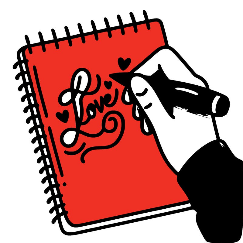 a hand writing “love” in calligraphy on a notebook