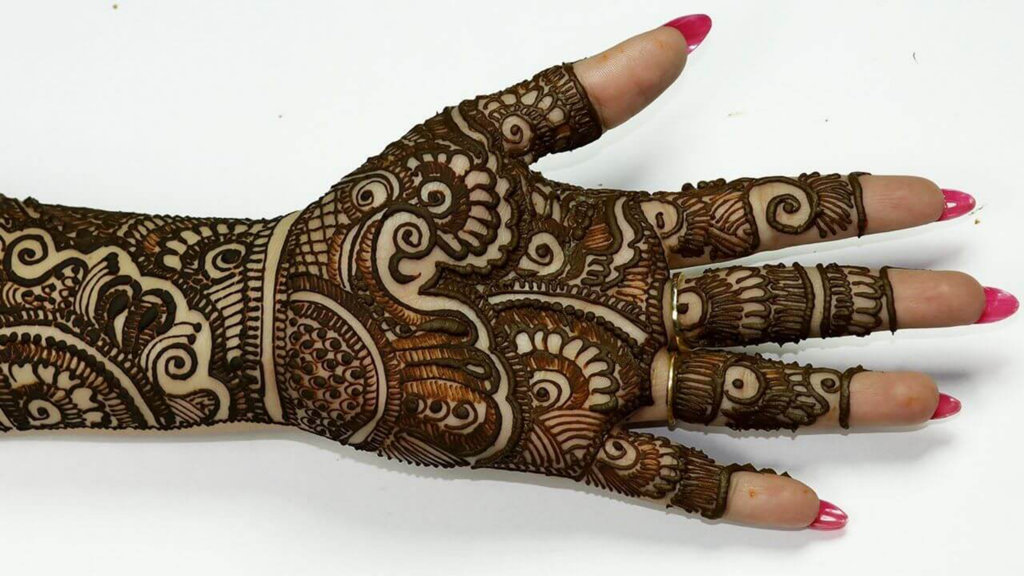 Intricate bridal mehndi henna design on a hand palm and forearm