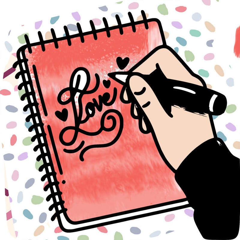 a hand writing “love” in calligraphy on a notebook