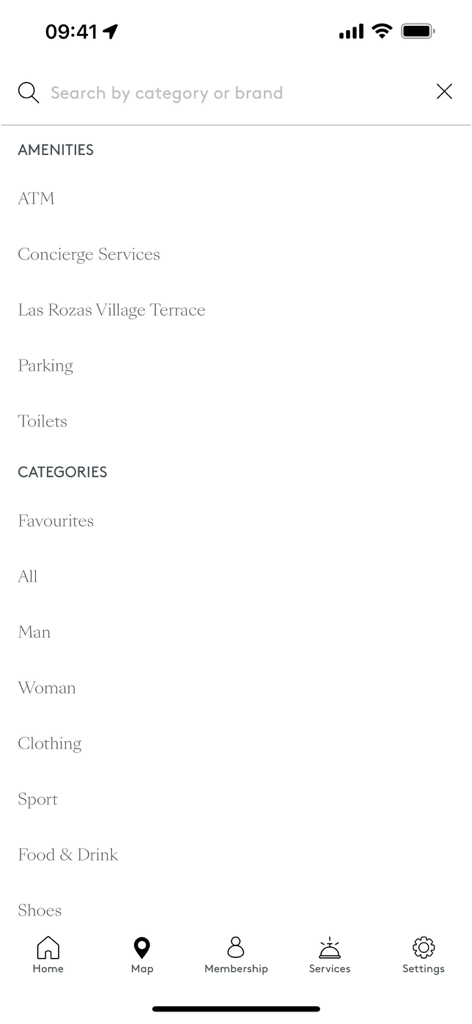 Menu de pesquisa no aplicativo Las Rozas Village mostrando comodidades do shopping e categorias de compras.