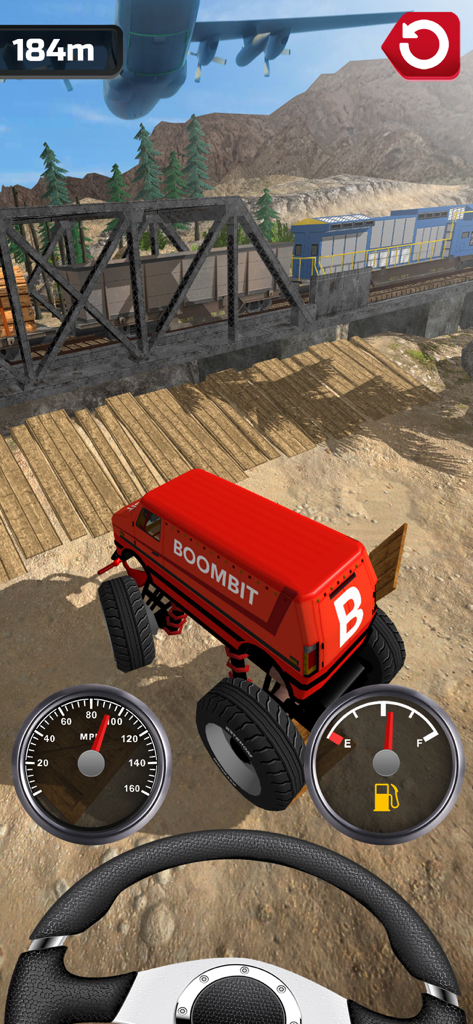 A red monster truck driving through a desert landscape chasing a plane overhead in the Plane Chase mobile game