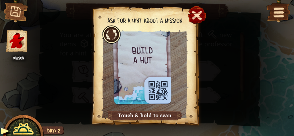 A screenshot of the Toriki board game app showing the QR code scanner interface to get a mission hint for building a hut.