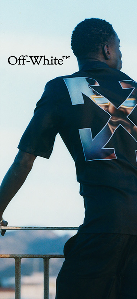 Off-White - A person wearing a black Off-White shirt with the brand's signature arrow logo on the back.