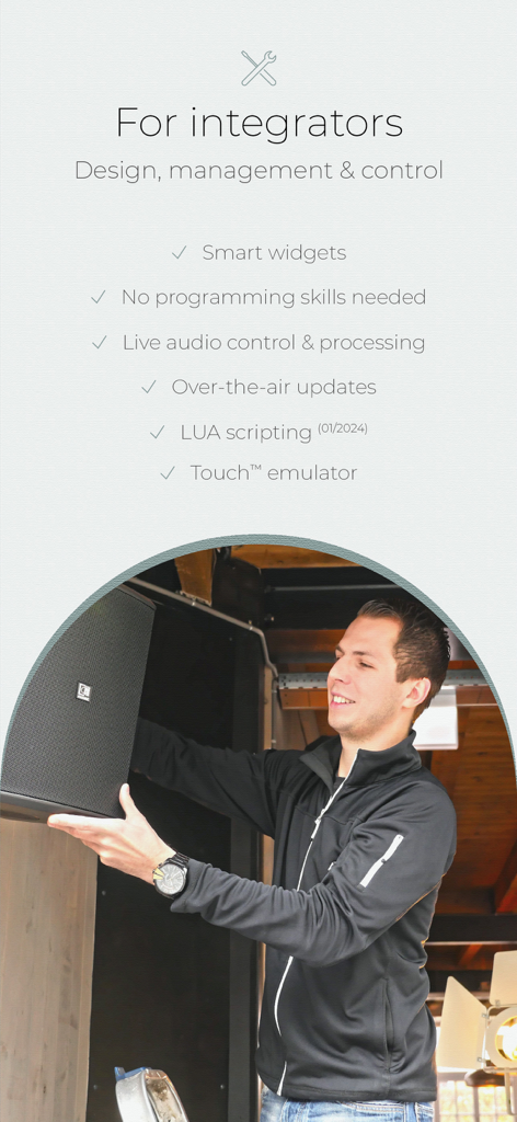 AV technician installing a speaker with a list of AUDAC Touch 2 system control features