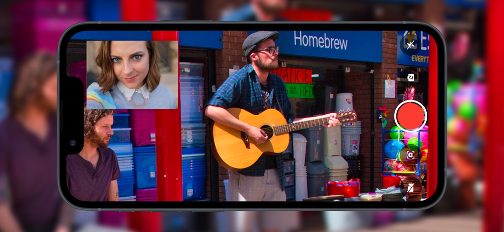 Double Camera: Video Recording - Smartphone screen displaying dual camera video recording of a street musician and a selfie.