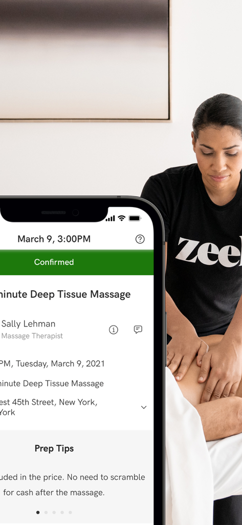 A smartphone displaying a confirmed Zeel deep tissue massage booking with a therapist in a branded t-shirt in the background
