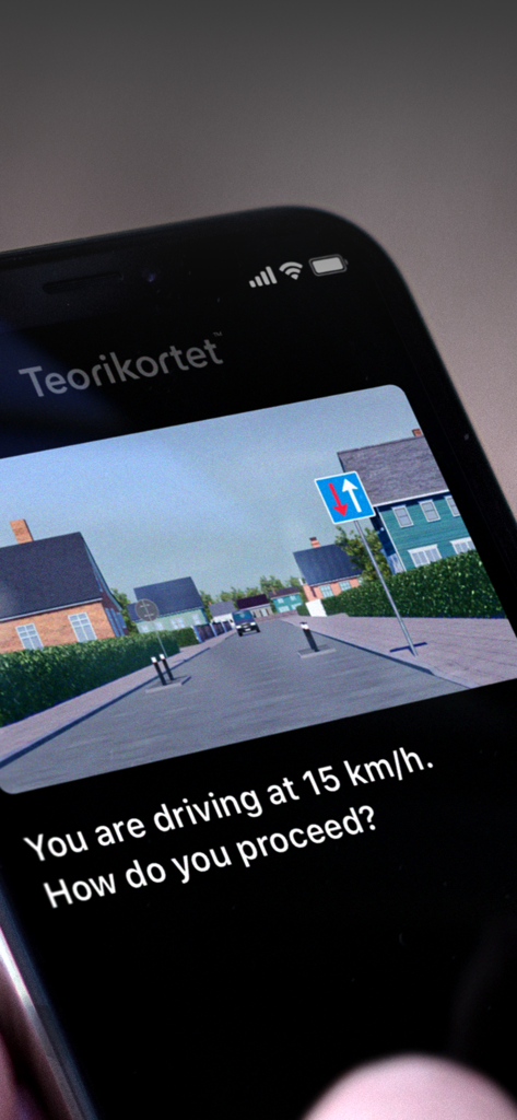 A smartphone screen showing the Teorikortet app with a driving theory practice question in English and a traffic simulation.