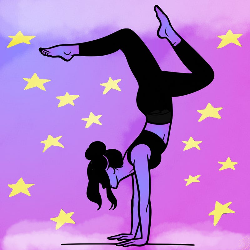 a woman doing a handstand