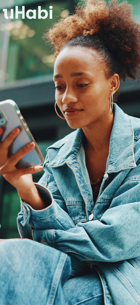 uHabi - A young woman using the uHabi mobile app for property management.