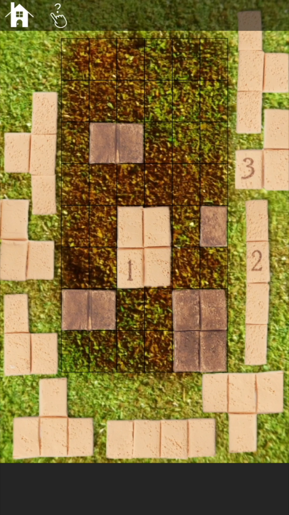 Escape game: MiniatureLAND - A top-down view of a block-fitting puzzle on a grassy field in MiniatureLAND.