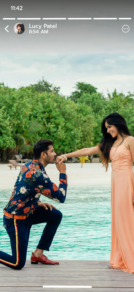 Save Status - Video Saver - 熱帯のビーチで、男性がひざまずいて女性の手をキスしている様子。