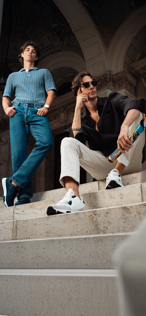 DRK - Two men modeling DRK sneakers and urban apparel on architectural stone steps