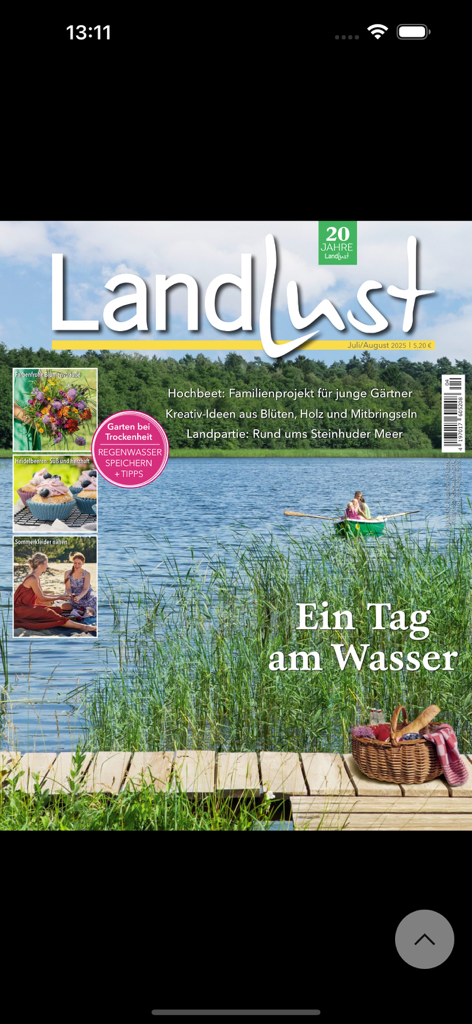 Landlust - Digital magazine cover of Landlust app featuring a peaceful lake scene and a picnic basket on a wooden dock