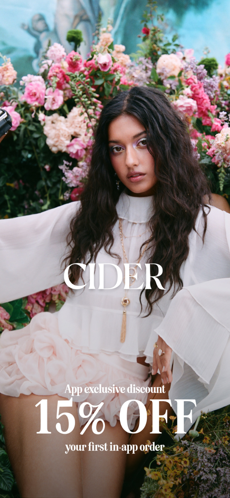 CIDER - Clothing & Fashion - Cider fashion app promotional image offering a fifteen percent discount on the first order with a woman in a floral setting.