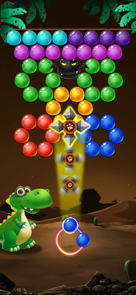 A green dinosaur character shooting bubbles in a desert-themed puzzle game