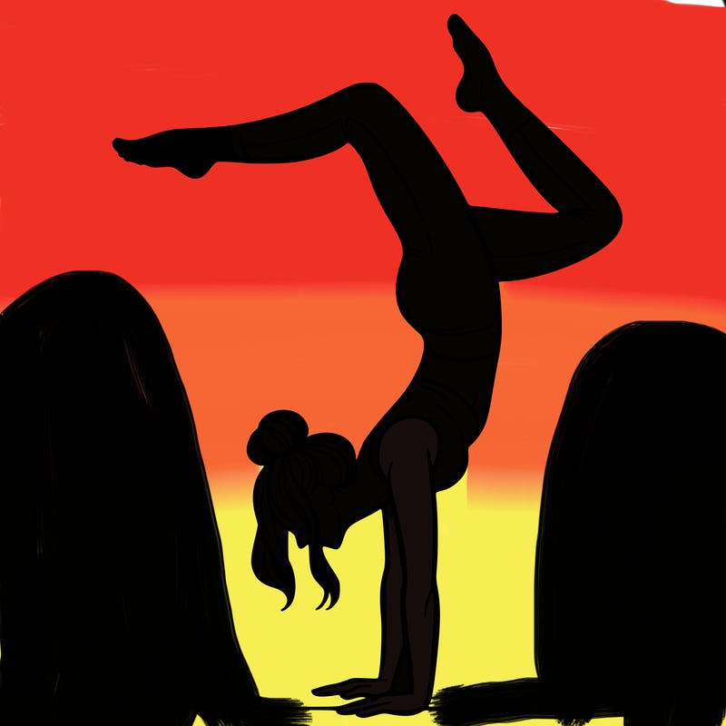 a woman doing a handstand