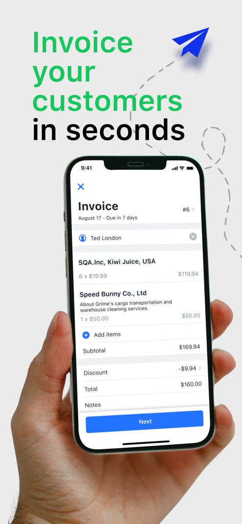 Hand holding a smartphone displaying a professional invoice creation screen for freelancers and small businesses.