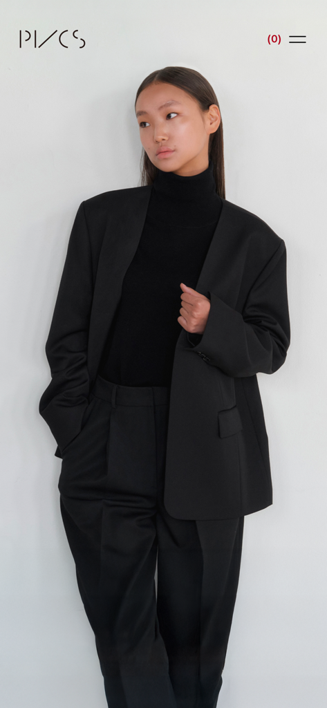 Model wearing a black minimalist suit on the PVCS shopping app