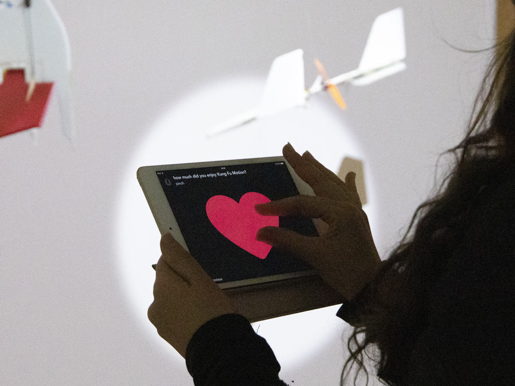 A museum visitor using the muse app on an iPad to provide feedback with a heart emoji.