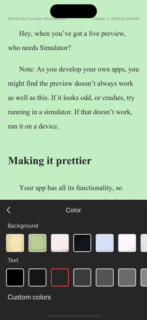 Reading interface of the eBooks app showing an open technical book with a green background and a color selection menu for background and text customization.