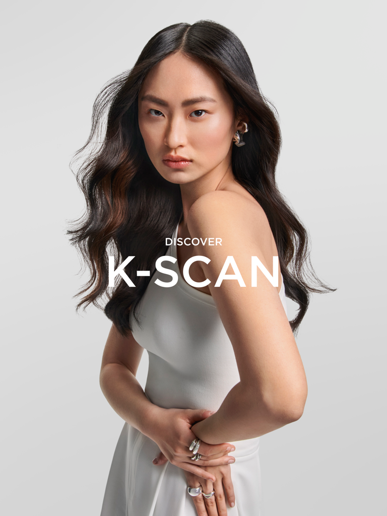 A professional model with healthy wavy hair promoting the K-SCAN app by Kerastase