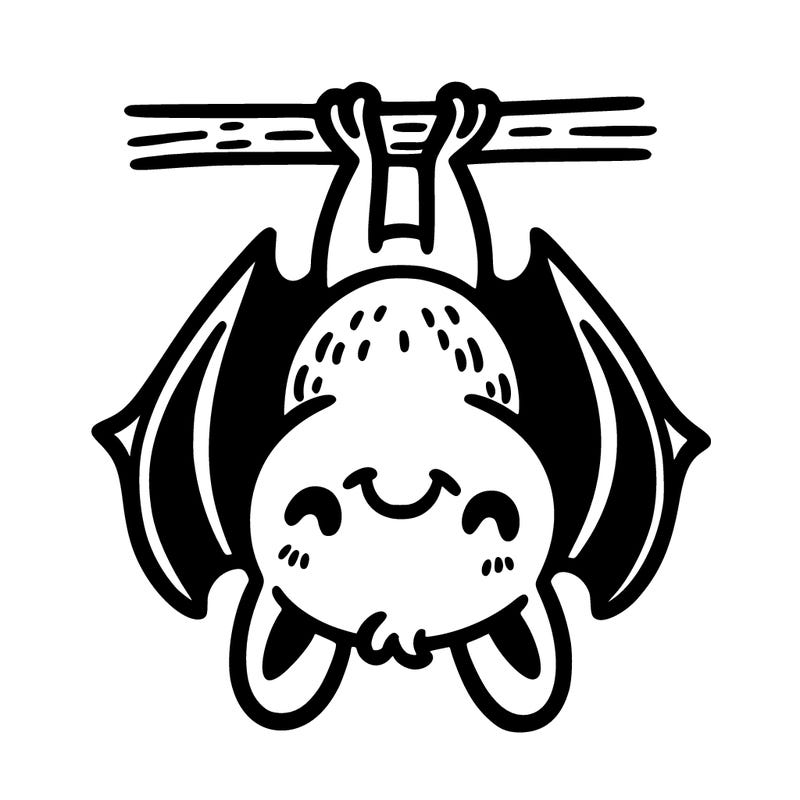 a bat hanging upside down with a grin