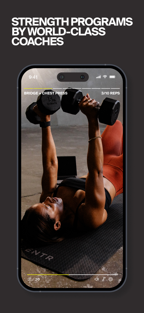 A woman performing a chest press exercise with dumbbells during a Centr app strength program.